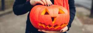 person holding a jack-o-lantern