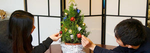 Kids decorating a rosemary christmas tree