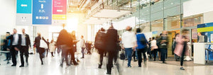 People walking through a large conference hall