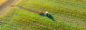 tractor tilling green field