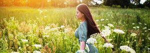 woman running through wildflower meadow