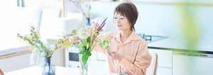 woman arranging cut flowers