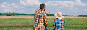 father teaching child about the family farm