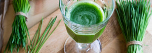 glass of wheatgrass juice on table