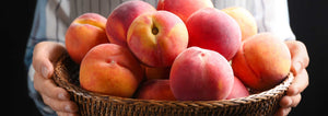 woman holding peaches