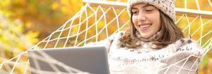 woman on her laptop in a hammock